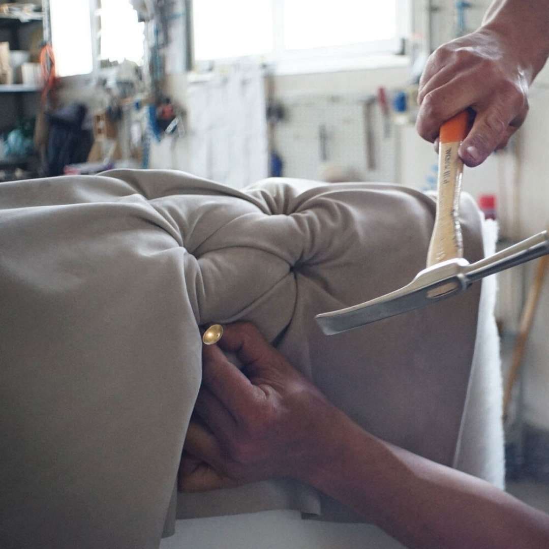 Professional upholstery repair services – worn-out couch undergoing reupholstery.