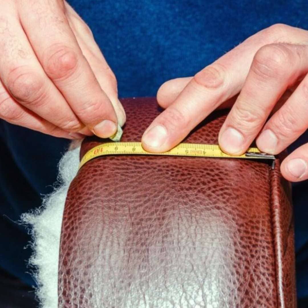 Leather furniture repair – close-up of damaged leather undergoing professional restoration.